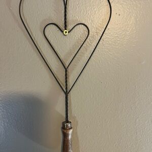 Vintage or antique primitive rug beater featuring a heart-shaped design